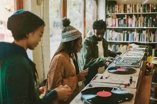Group of people in Recusrsive Records listening to music and socialising during a listening party event